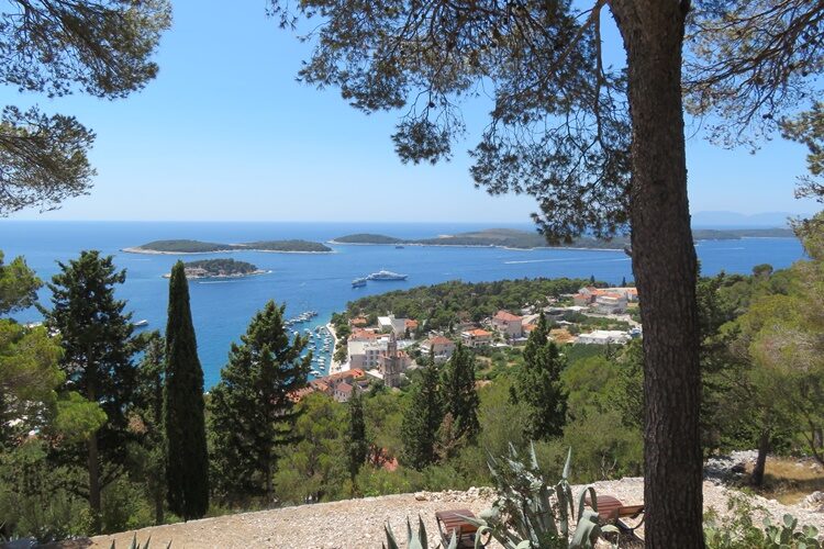Located in the Adriatic Sea, the Island of Hvar is one of the most popular summer destinations in Croatia. It’s impressive to note that the tourism industry in Hvar started blooming more than one hundred and fifty years ago. Even today, people are seduced by this island’s charming fishing villages and the spectacular architecture throughout the island. Tourists keep coming back year after year. It is not just the history of the island and its incredible five UNESCO sites, but also its cultural heritage, which is celebrated throughout the seasons with various festivals. These festivals tend to revolve around the rich agricultural history including almond, lavender, olive, and wine production which make Hvar a place like no other. Read on for the ultimate guide to the Island of Hvar! History of the Island of Hvar The Island of Hvar may have gained popularity among tourists in the last couple hundred years, but its history dates all the way back to pre-historic times. Incredible ceramic pieces have been unearthed across the island, which prove human habitation during the Neolithic period. Later on, the ancient Greeks chose this island, the longest of the Croatian Islands, as their new home. Approximately 2,400 years ago, they were also the first to build an entire city on the island, which boasted fortified walls and became the settlement for more than one thousand inhabitants. Between the 15th and 18th century, the island of Hvar was under the rule of the Republic of Venice. But it was during the Austro-Hungarian empire when the island began to find prosperity through the growth of its successful fishing fleets, which sailed across the Mediterranean. It is this unique combination of several cultures and traditions which make the island of Hvar so vibrantly colorful and one-of-a-kind! From strolling down the ancient stone walls to exploring the unique Roman Villas, there is so much to do in Hvar. Wait no more; start planning your own ultimate trip to the Island of Hvar! What to Do: Explore Hvar Town As the largest city on the island, the city of Hvar has plenty to offer, and it is the best spot to begin your holiday adventure. Historic paradise, restaurant heaven, hiker’s wonderland, and party district are all accurate descriptions for this vibrant town. The history buffs can head all the way up to the top of the hill to reach the 15th century Fortica Fortress (Spanjola). Pay a visit at dusk for a sunset view of the most breathtaking scenery across the island. For those who love to fully immerse themselves in the atmosphere of the destination, steep steps through stone alleys decorated with colorful flowers and trees are an excellent choice to experience. Or, rent a scooter or buggy from Rapidus; e mail them for reservations, or show up near the bus station to rent on a first-come-first-served basis. You can also take sightseeing tours to get to the top of the fortress to see the view. Numerous party cruises also leave the Port of Hvar and sail around this Dalmatian Island all night, offering the nightlife seekers the ultimate party tour. There truly is something for everyone here. Stari Grad Situated on the northern side of the island, Stari Grad is another must-visit destination on the Island of Hvar. Among Europe’s oldest cities, Stari Grad will welcome you with its rustic, authentic, historic charm. If you find Hvar to be too touristy and crowded, Stari Grad is the perfect remedy with its laid-back, relaxed atmosphere. It is restorative and peaceful to just stroll down its picturesque, narrow streets, lined with quaint cafes and restaurants. As the calm of this serene place washes over you, you will feel like you have found a peaceful hidden gem. Stari Grad means “old town”, and there is an artist community here. Protected by UNESCO, the family-owned Hora Farm is another must-visit when in Stari Grad, especially for wine lovers. You will be definitely treating yourself to the most unique wine tasting experience you have ever had! Jelsa Just a 30-minute drive away from the city of Hvar, visitors should definitely pay a visit to the quiet and peaceful town of Jelsa. While the 17th century Baroque chapel is the most iconic sight in the town, it’s the wide range of festivals running year-round, which make Jelsa one of the best destinations in Croatia. The Nights of Antun Dobronić is among the most well-known of these events, and takes place in August. This festival offers visitors to Jelsa the chance to take a closer look at the culture and folklore of the area. Another must-attend event that highlights local produce is the Jelsa Wine Festival, which takes place on the last weekend of August each year. Where to Stay Amazing accommodation options are truly endless - from a wide variety of apartment rentals or hotels inside the town center of Hvar, to beautiful villas on top of the hills, to cottages by the sea. The hard pick is picking one! Apartments range from about 120-400 Euro a night, but there are some options that are less. The historic Palace Elizabeth has been freshly renovated and is the most luxurious boutique hotel on the island. Equally remarkable is the 4-star Blue Bay Residence, which not only has direct beach access, but also greets you with a spectacular view of the endless blue Adriatic Sea each morning. Where to Eat Hvar Town Lungo Mare Hvar, e mail them for reservations because they are often booked. Jelsa Restaurant & Apartment MURVICA, e mail them for reservations How to Get There In order to travel to Hvar, you will take a ferry from Split, or, if you’re not bringing a vehicle, catamarans are the faster option. If you are bringing your car, then you need to take the ferry. If you’re bringing a dog, use Krilo for the catamaran because you can sit with your dog with no issue. The company Jadrolinija doesn’t allow dogs on catamarans, only on their ferry which takes much longer. Parking on the island is both easy and cheap, which makes taking your car totally worth it. Not having to rely on public transportation is also great, as you will have the flexibility to plan your own travel itinerary across the island of Hvar. Travel Tips: Make sure to bring a swim coverup. It is illegal and there is actually a high fine for walking around Hvar town in just your bathing suit. You will need to be covered on both top and bottom to keep from getting a 600 Euro fine. This also applies to men. Bring good shoes for walking. There is a lot of walking to sightsee around the towns, especially in Hvar town. Everything is uphill or up steps. Bring lots of cash, as most restaurants, bars and stores only take cash, or at the very least, offer a discount if you use cash. If they do accept credit cards, they are likely going to apply an extra “tax” or fee for using card. Also, get your cash ahead of time, as the ATMs charge so much extra for taking money out on the islands. You’ll need about 300-600 Kuna for 2 people to have a nice meal (like fish with all the fixin’s). Of course, you can find basic meals to eat for about 70-90 Kuna a meal if you’re on a budget. Hotels and apartments are all at least 120 Euro a night. The prices are going up fast, so this might be totally different by summer of 2022. Taxis are always 100 Kuna in the center of Hvar town. If you’re going to Jelsa, it’s about 400 Kuna to take a taxi. This is why I recommend taking your car if you have one. Hvar town is the most expensive place on the island, so plan accordingly. If you’re from the West, pricing is pretty comparable to what you will spend in a mid-sized city. Bring your dog, as this is a dog friendly island. Apartments and hotels are dog friendly, and the restaurants will love your dog. If you have a very large dog, you may run into a couple challenges, but I noticed shepherds, labs, and other big dogs everywhere. My little guy, Onawa, was allowed everywhere. I hope you get to come and see all this amazing island has to offer, as it is just a stunning place and a culturally rich experience. Be sure to subscribe for more Croatian travel guides, tips, and adventures.